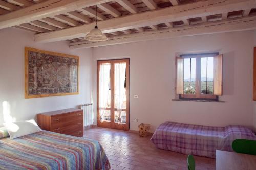 a bedroom with a bed and a dresser and windows at Alloggi degli Artisti in Case Selva Grande