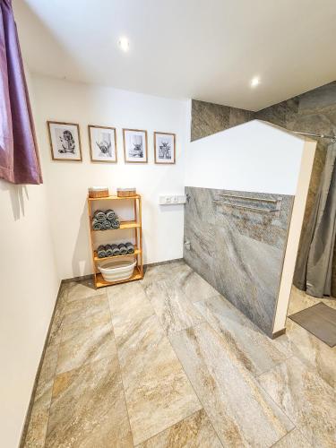 a bathroom with a shower and a tile floor at Ferienwohnung auf dem Stroblhof in Polling