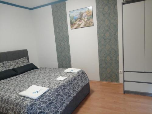 a bedroom with a bed and a picture on the wall at Apartments Angie in Biograd na Moru