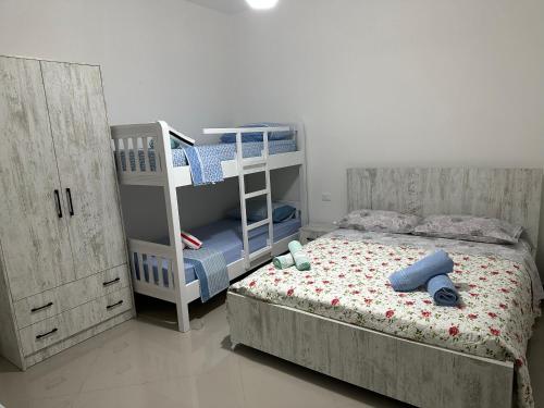 a bedroom with a bunk bed and a ladder at Hotel Restorant Anxhelo in Draç