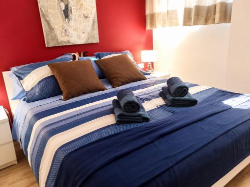 a blue bed with towels on top of it at Solymar Premium Apartment in Playa del Ingles