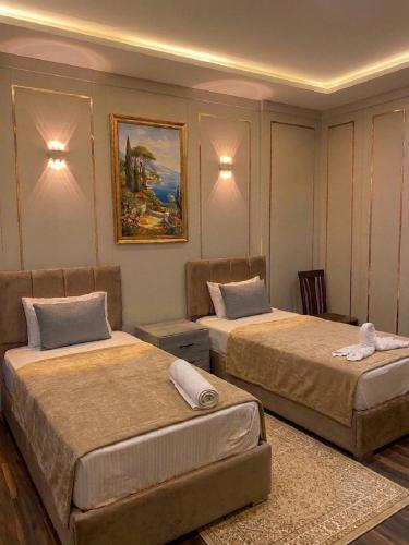 a room with two beds in a room at Aura Downtown Suites in Cairo