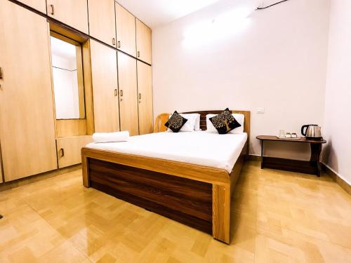 a bedroom with a large bed in a room at Aishwaryam Hotels & service Apartment in Madurai