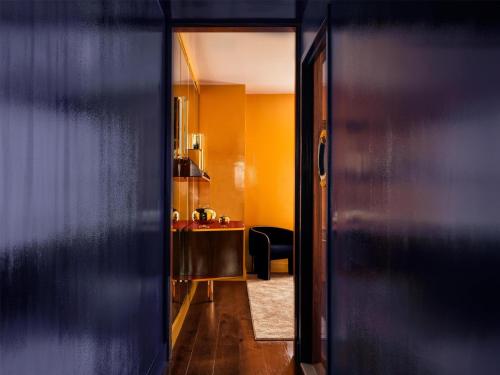 an open door to a room with a desk at The Manner, The Unbound Collection by Hyatt in New York