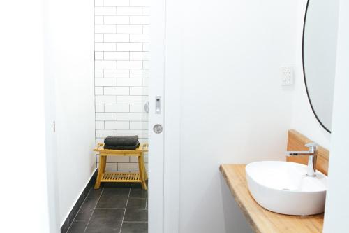 a bathroom with a sink and a mirror at The Kyneton Hotel in Kyneton