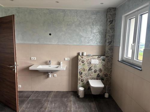 a bathroom with a sink and a toilet at Flachsberg in Huf