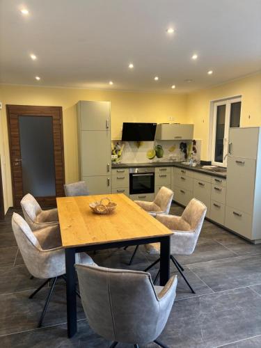 a kitchen with a wooden table and chairs at Flachsberg in Huf