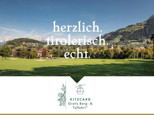 a picture of a golf course with mountains in the background at Rasmushof - Hotel Kitzbühel in Kitzbühel