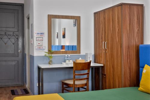 a room with a desk with a mirror and a chair at Hanoi Sihouse Eco in Hanoi