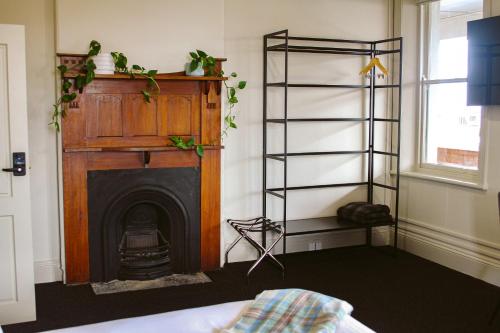 a living room with a fireplace and a fire place at The Kyneton Hotel in Kyneton
