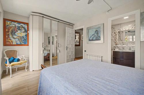 a bedroom with a large bed and a bathroom at Casa Del Sol in Calafell