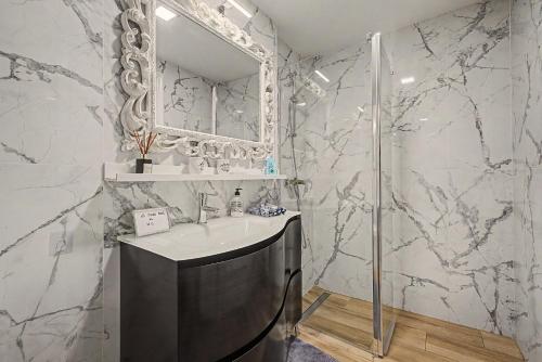 a bathroom with a sink and a mirror at Casa Del Sol in Calafell