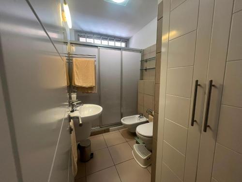 a bathroom with a toilet and a sink at Casa Médano 12 in El Médano