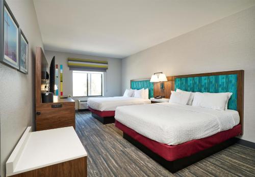 a hotel room with two beds and a television at Hampton Inn & Suites Salinas in Salinas