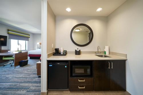 a kitchen with a sink and a mirror in a room at Hampton Inn & Suites Salinas in Salinas
