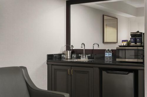 a bathroom with a sink and a mirror at Doubletree by Hilton, Leominster in Leominster
