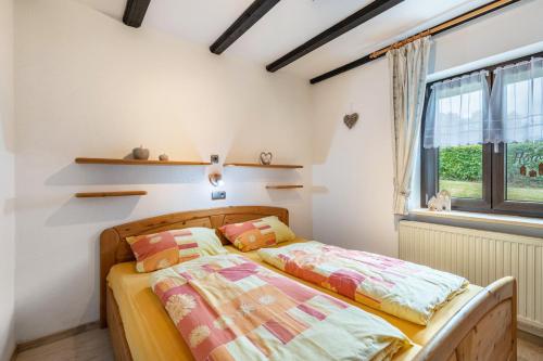 a bedroom with a bed and a window at Ferienwohnung Bayerwald in Arrach