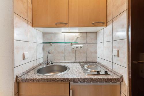 a small kitchen with a sink and a counter at Ferienwohnung Bayerwald in Arrach