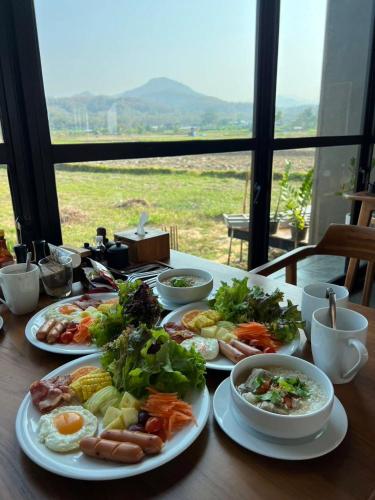 a table with plates of food on top of it at The field@pua เดอะฟิลด์แอทปัว in Pua