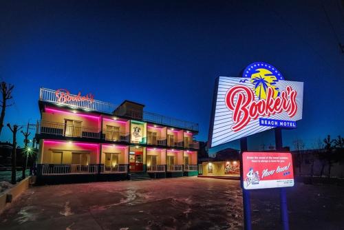a building with a neon sign in front of it at Yangyang Bookers Beach Motel in Yangyang