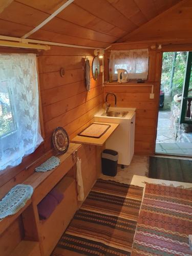 a kitchen in a log cabin with a sink at EkoPens in Radziszów