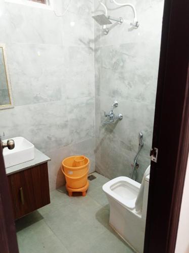 a bathroom with a shower and a toilet and a sink at Hotel rose palace in Dehradun