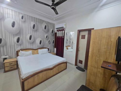a bedroom with a bed and a wall with posters at Collection O Guru Nanak Dev University Amritsar Formerly Hotel Tashi in Amritsar
