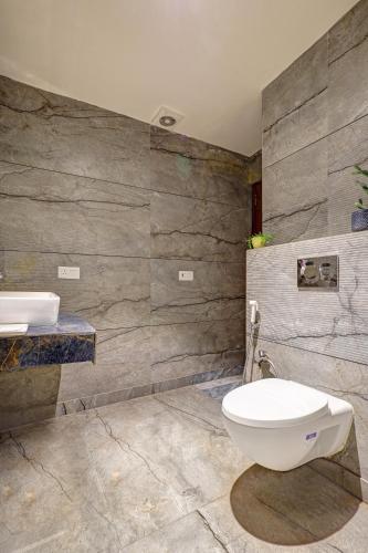 a bathroom with a toilet and a sink at Lavanya Hotel- Near Alipur, Delhi in New Delhi