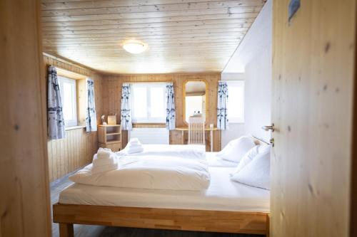 a bedroom with two white beds in a room at Chasa Macun in Schleins