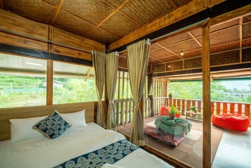 a bedroom with two beds and a balcony at Vanhaus in Sapa