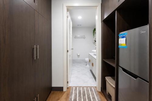a hallway with wooden cabinets and a bathroom at Cebu Airport Layover Stay in Pusok