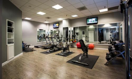 a gym with several treadmills and cardio machines at Hotel Deco in Omaha