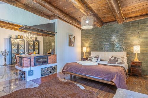 a bedroom with a large bed and a fireplace at Villa São Jorge in São Jorge
