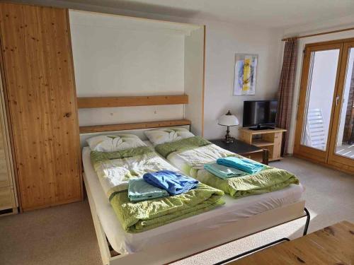 a bedroom with a bed with two pillows on it at ELAfora Studio in Salouf