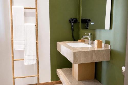 a bathroom with a sink and a mirror at Lankraz Hotel Mauritius in Port Louis