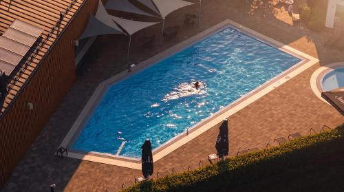a swimming pool with a person in the water at Mobile Homes Camping Plitvice in Smoljanac