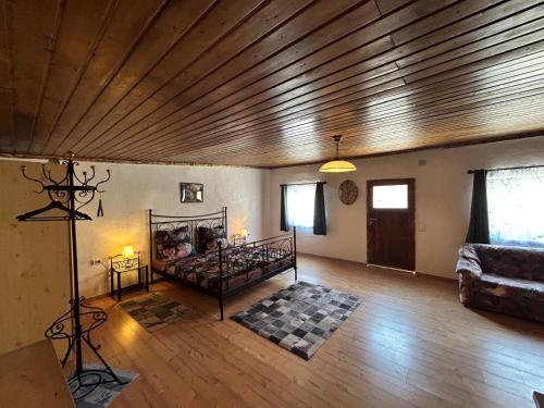 a bedroom with a bed in a room with a wooden ceiling at Zum Alten Pferdestall in Eppingen