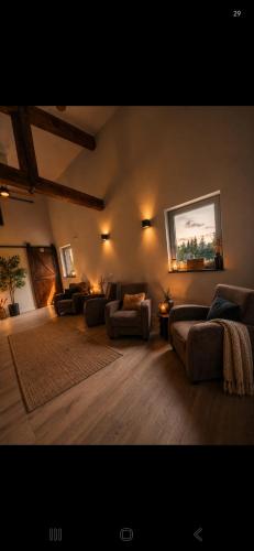 a large living room with couches and a rug at Shepherd Hutten Hunsel in Hunsel