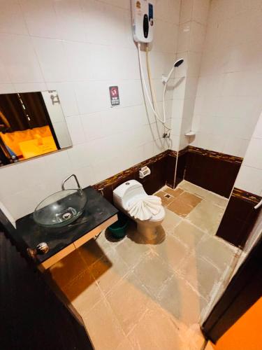 a bathroom with a sink and a toilet at Silver Oaks Hotel in Patong Beach