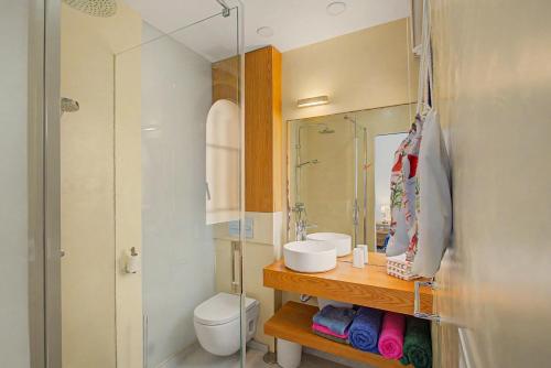 a bathroom with a sink and a toilet and a mirror at Bungalow meloneras in San Bartolomé