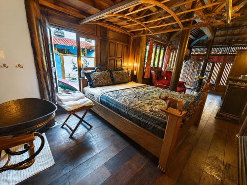 a bedroom with a bed and a table in a room at Thien Y Villas in Hue