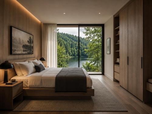 a bedroom with a large bed and a large window at De Holiday Home in Haenertsburg