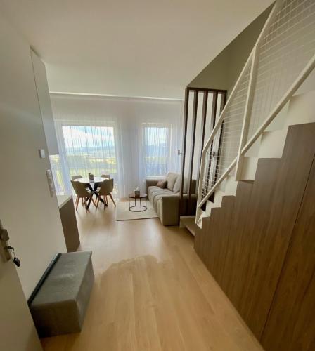 a living room with a couch and a table at Elite Gerlach Mezonet in Svätý Jur