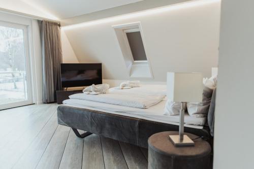 a bedroom with a bed and a table with a lamp at Villa Vivaldi in Kühlungsborn