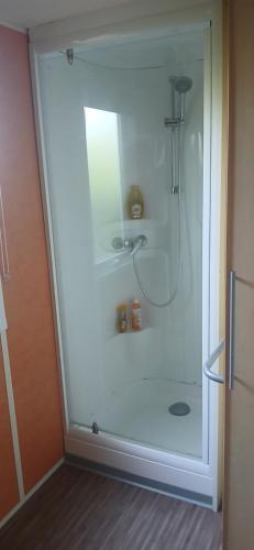 a shower with a glass door in a bathroom at Far west location in Vironchaux