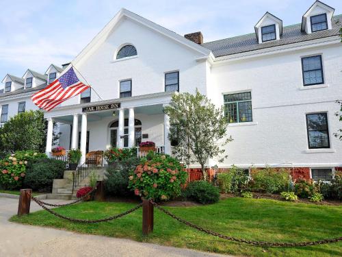 a white house with an american flag on it at Jailhouse Inn in Newport