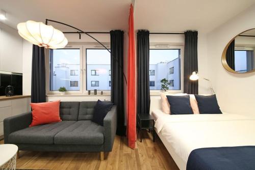 a living room with a bed and a couch at A very cozy apartment with a large bed in Wrocław