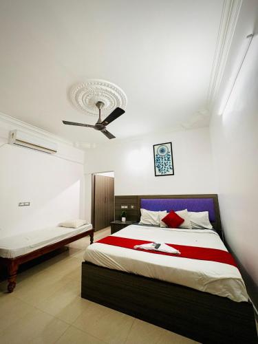 a bedroom with two beds and a ceiling at Serenity beach side in Pondicherry
