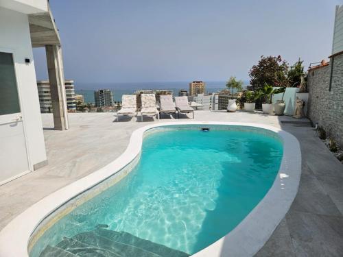 a swimming pool on top of a building at New Luxury Villa Tuulia with private pool and parking in Fuengirola