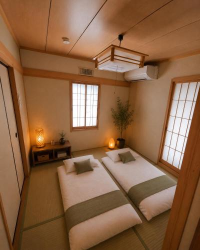 two beds in a room with two windows at 湖畔の詩 BBqが楽しめる隠れ家 琵琶湖徒歩5分 in Takashima